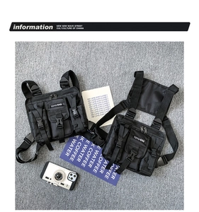 Detail of black tactical chest rig with MOLLE webbing and adjustable buckle straps