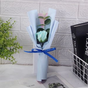 Detail of single blue soap rose bouquet with Just for you ribbon and blue paper wrap