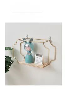 Detail of gold geometric iron wall shelf with solid wood base for modern home storage
