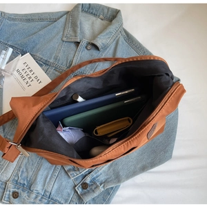 Detail view of large capacity nylon tote interior with zip pocket and daily essentials
