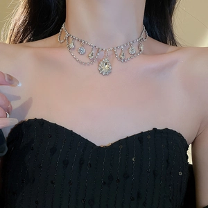 Close-up of luxury teardrop rhinestone choker with sparkling silver tassel detail