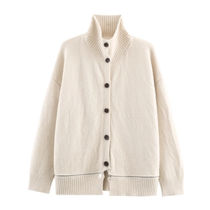 Détail d'un cardigan en maille beige avec col montant et ourlet à fermeture éclair