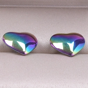 Macro shot of iridescent rainbow heart stud earrings in 304 stainless steel and jewelry box
