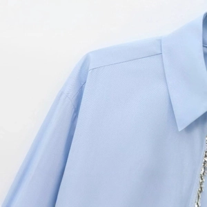 Light blue long sleeve poplin shirt with rhinestone embellishment and woven texture