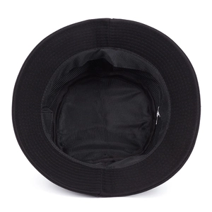 Interior view of black cotton bucket hat showing sweatband and white fabric label