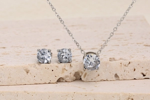 Detail of 18K plated stainless steel jewelry set with round cubic zirconia on stone base