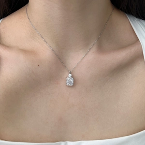 Detail of S925 silver necklace with emerald-cut crystal pendant on female collarbone