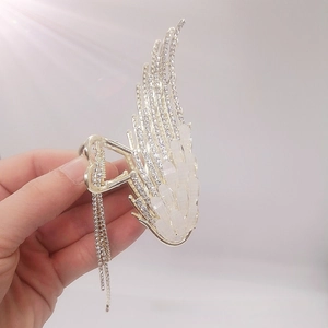 Detail of angel wing hair claw with rhinestones, opal accents and elegant tassels