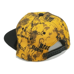 Detail of yellow hip hop snapback cap with black graffiti print and adjustable strap