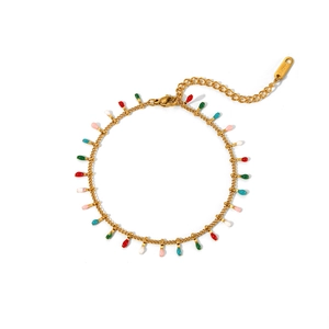 Detail of a golden stainless steel bracelet with colorful enamel waterdrop charms