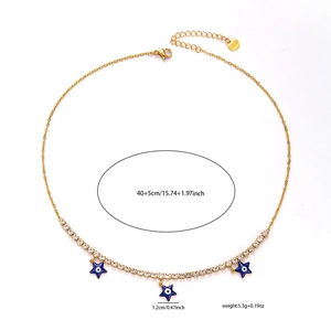 Detail view of gold titanium steel necklace with blue evil eye charms and s.steel tag
