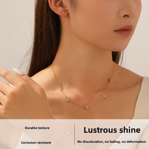 Close-up of gold star and moon jewelry set with sparkling rhinestones on model