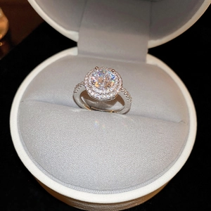 Macro shot of silver dual-band ring with brilliant cubic zirconia in a white jewelry box