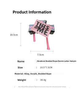 Detail view of denim fabric bow hair claw with embroidered patch and size specifications