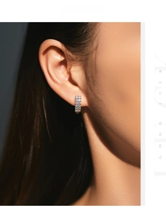 Close-up of luxury S925 silver U-shaped hoop earrings with double row paved zirconia