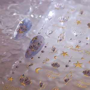 Golden ocean theme nail stickers with seashells, stars and pearl shell motifs
