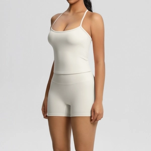 Detail of a beige two-piece yoga set featuring thin straps and high-waisted shorts