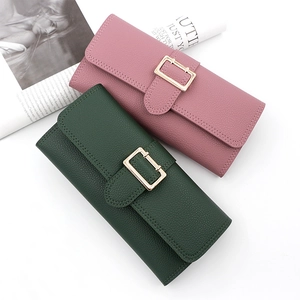 Close-up of elegant long PU leather wallet with litchi texture and gold metal buckle