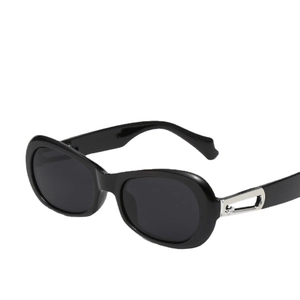 Fashionable black oval sunglasses with silver metal temples on a clean white background