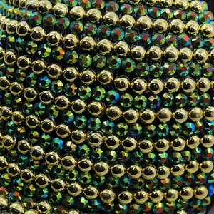 Detail of baseball cap featuring luxury gold metal beads and iridescent green rhinestones