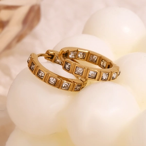 Detail of 18K gold-plated stainless steel hoop earrings with square cubic zirconia