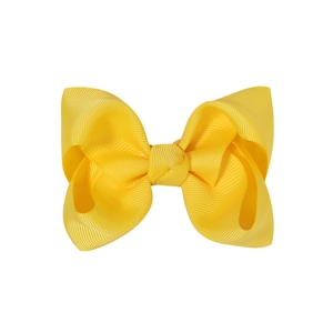 Detail of yellow grosgrain ribbon bow hair clip showing textured fabric and knot detail
