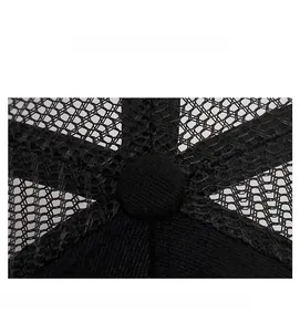Macro detail of breathable black mesh fabric and top button on a baseball cap