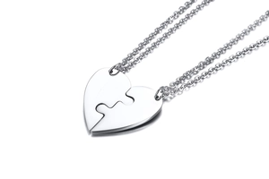 Detailed view of polished silver titanium steel heart puzzle pendants for four best friends