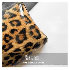 Detailed macro view of glossy leopard print leather with elegant gold metal frame edge