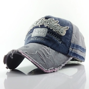 Detailed view of distressed 1969 embroidery and frayed edges on vintage baseball cap