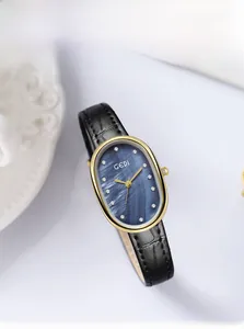 Detail of gold oval watch with blue mother-of-pearl dial and diamond markers