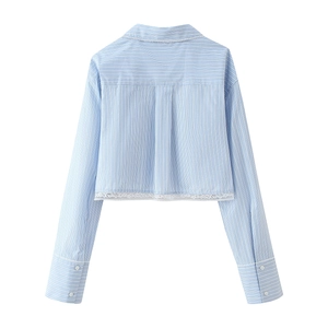 Back view of blue striped shirt featuring delicate white lace trim on the hem and cuffs