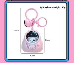 Pink cat space capsule keychain with pink bell and dimensions measuring 10.8cm in length