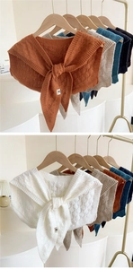 Detail view of colorful knitted shawl options with ribbon ties in multiple trendy shades