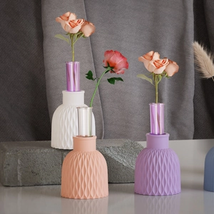 Detailed view of 3D wave-textured resin vase bases with elegant glass flower tubes