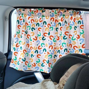 Detailed car sunshade for babies featuring colorful geometric patterns on a side window