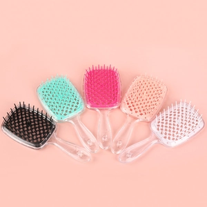 Hollow honeycomb hair brushes in multiple colors with transparent handles on pink background