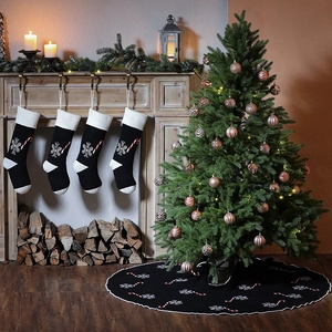 Knitted black Christmas tree skirt and stockings set with snowflake and candy cane patterns