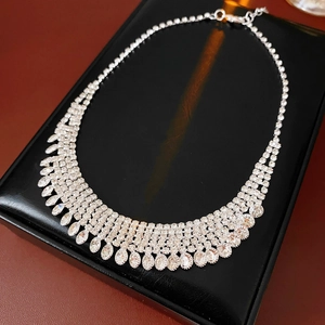 Detail of silver rhinestone fringe necklace with pear-shaped stones on black leather