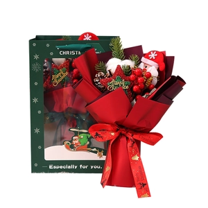 Christmas bouquet with Santa plush and pine cones in matching green gift carrier bag