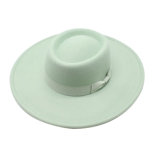 Close-up of mint green wool felt fedora with matching ribbon and flat top crown