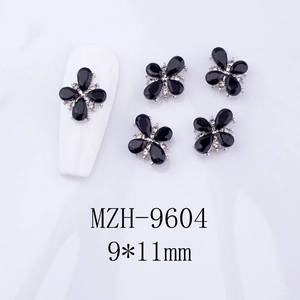 Detail of 9x11mm black flower nail charms with alloy base and crystal rhinestones