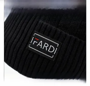 Close-up of black ribbed knit beanie featuring the IFARDI woven brand label detail