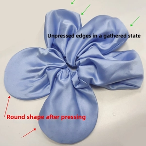 Detail showing oversized blue satin scrunchie before and after ironing for a round shape