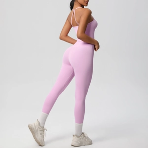 Detailed back view of pink backless yoga jumpsuit with cross straps and high-stretch fabric