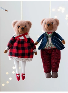 Detail of plush bear couple charms in red plaid dress and navy blue suit for Christmas