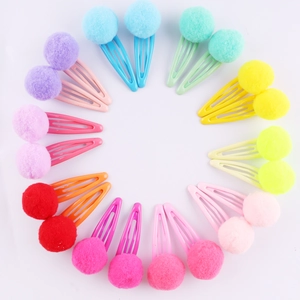 Macro shot of 24 colorful plush ball hair clips set with metal BB clips for little girls