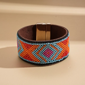 Detailed view of colorful beaded ethnic bracelet with metallic magnetic clasp and resin texture