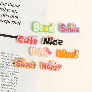 Close-up of candy-colored 3D resin letter charms with words like Happy and Sweet for DIY