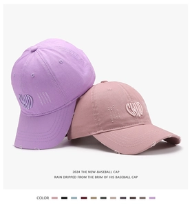 Detail of distressed brim and 3D letter embroidery on cotton twill baseball caps